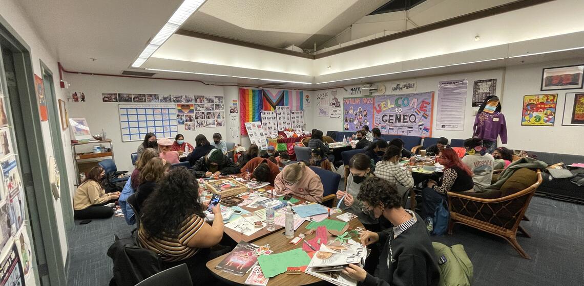 Students sit in Chavez 202 and make zines as part of an event