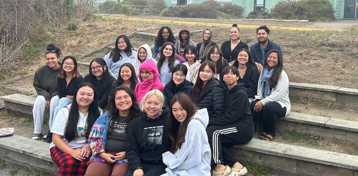 Group Photo of 30 people sitting on steps