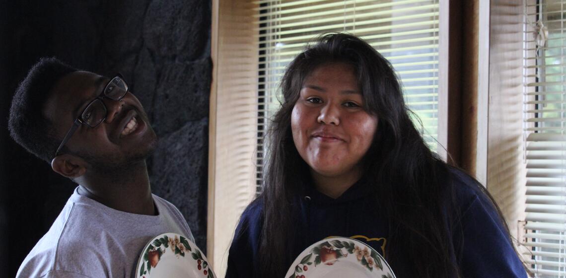 Two students posing for a photo smiling